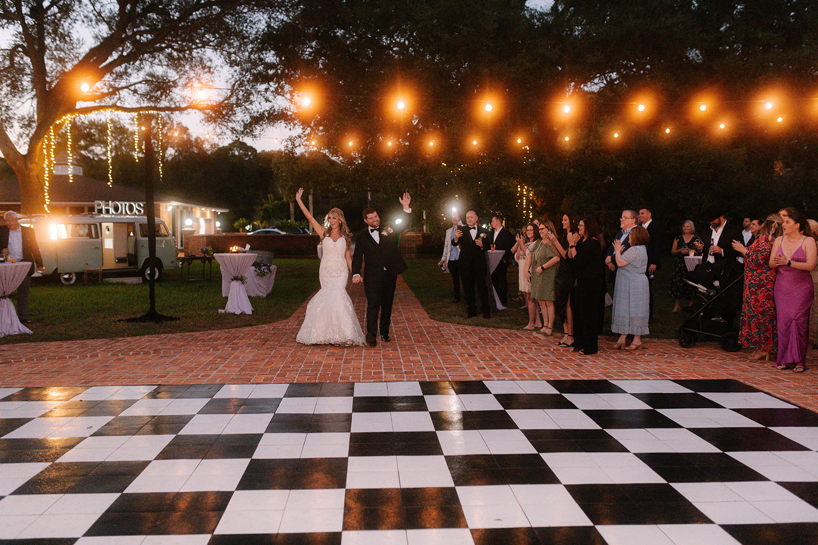 Bride and Groom Walking Out Waving to Guests