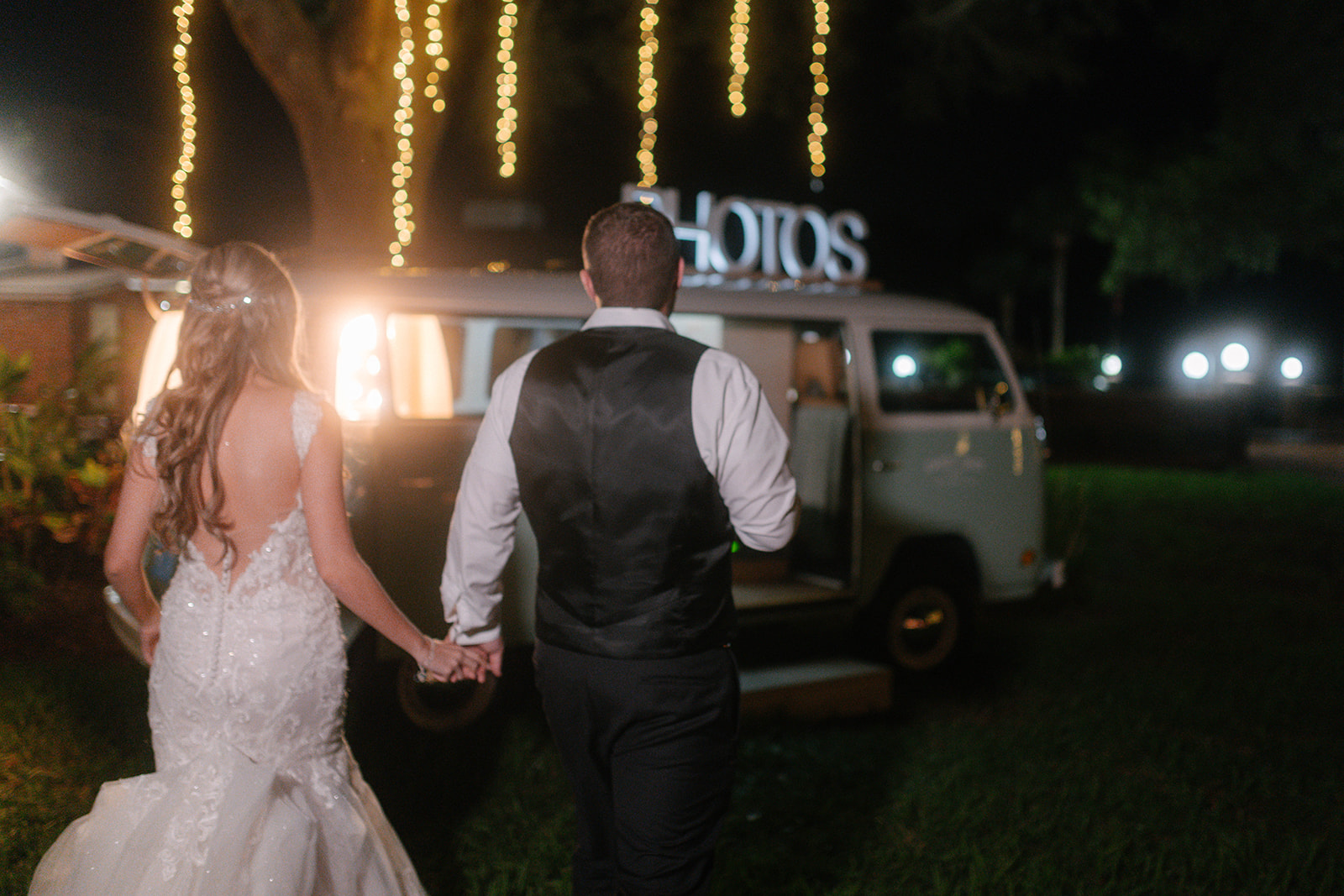 Bride and Groom Holding Hands Walking to a Photo Bus