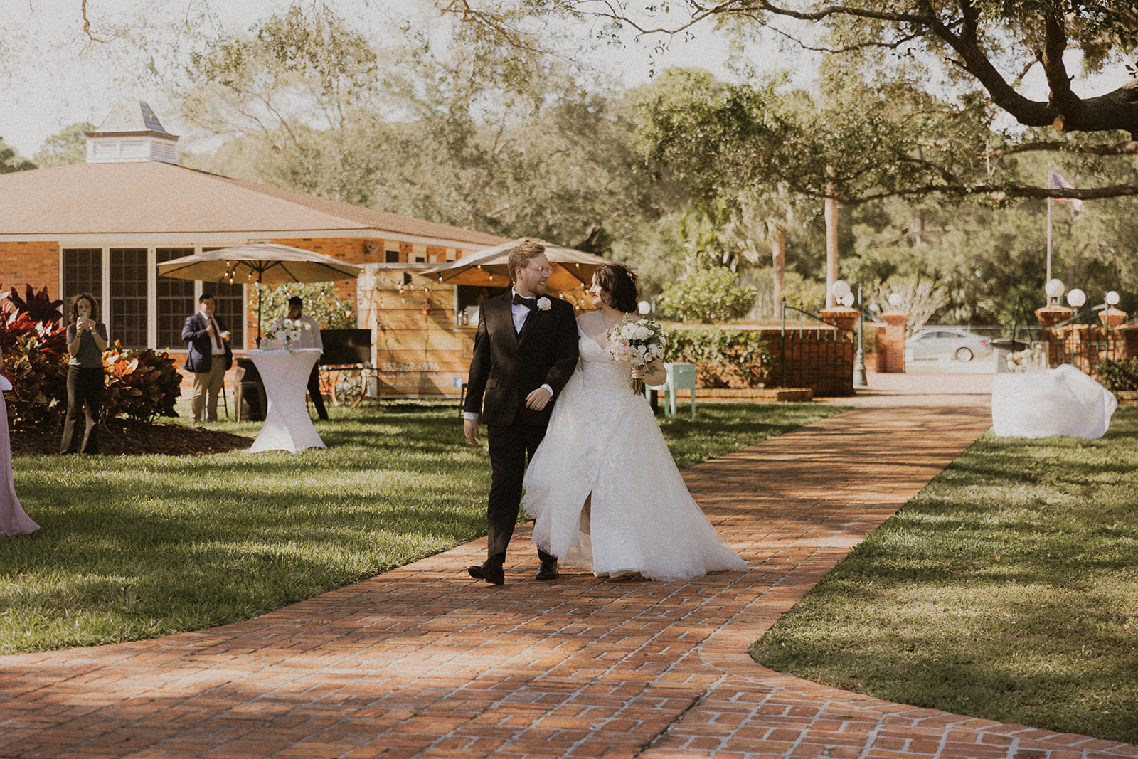 wedding couple walking on brick