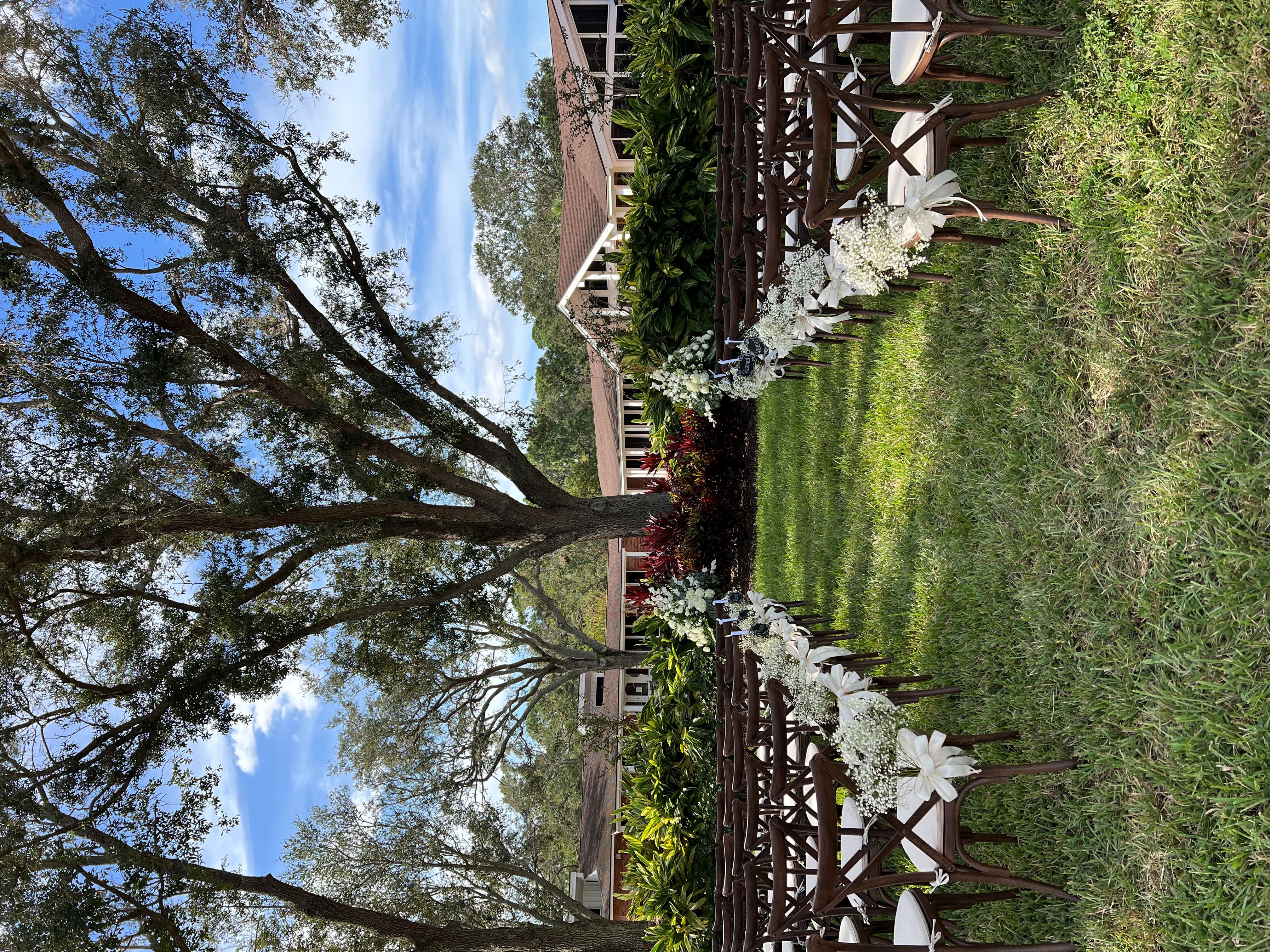 Wedding ceremony aisle lined with baby's breath and white flowers