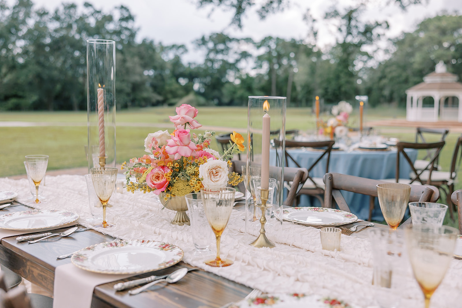 Farm tables with pink accents and round tables with blue accents for colorful spring wedding