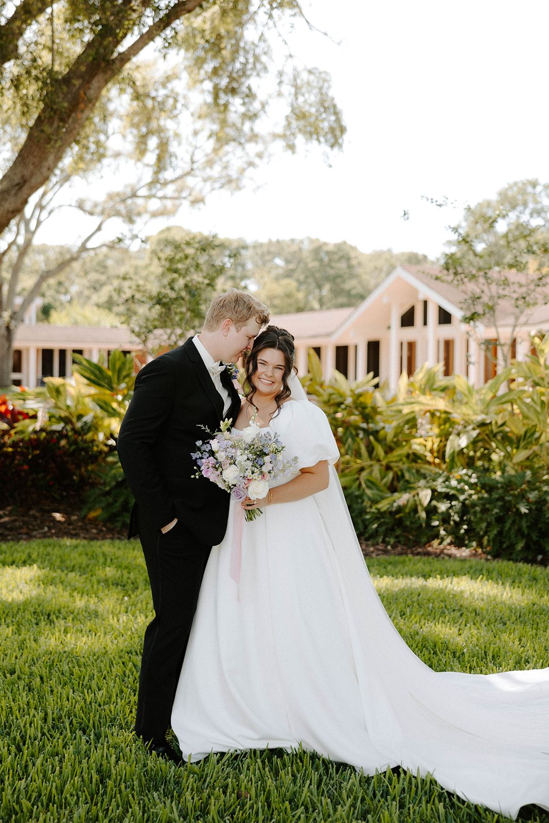 Bride and Groom posing under the oak trees