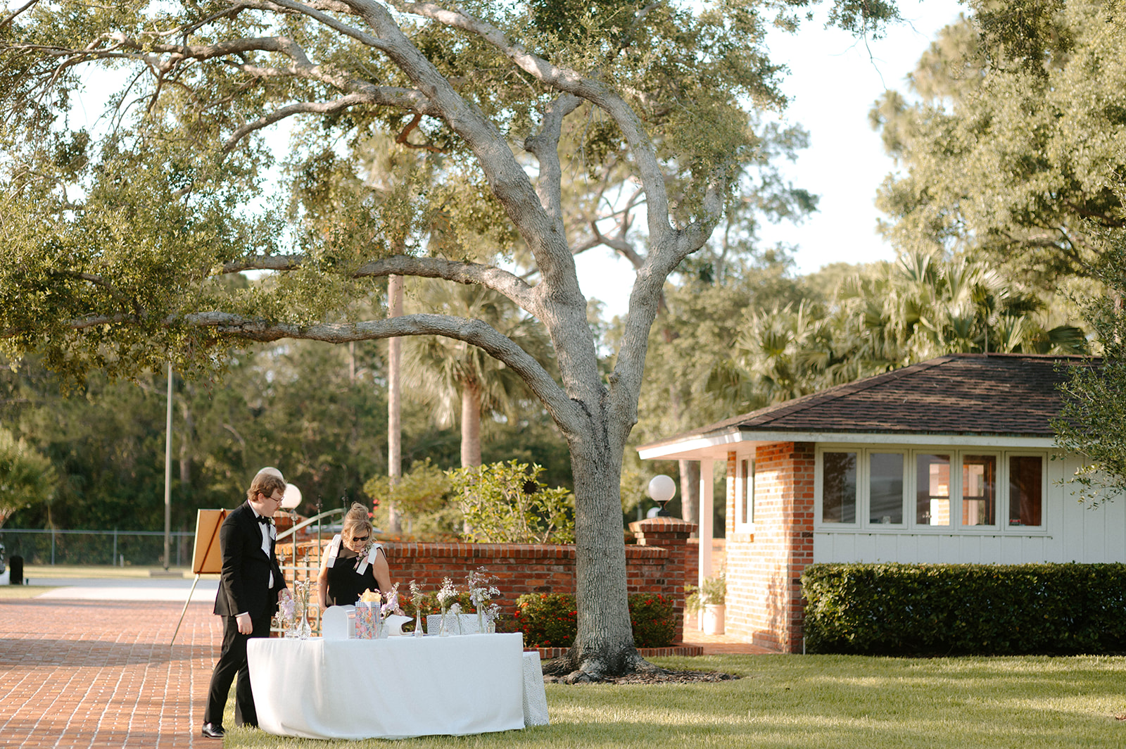 Guests signing guest book at wedding welcome table