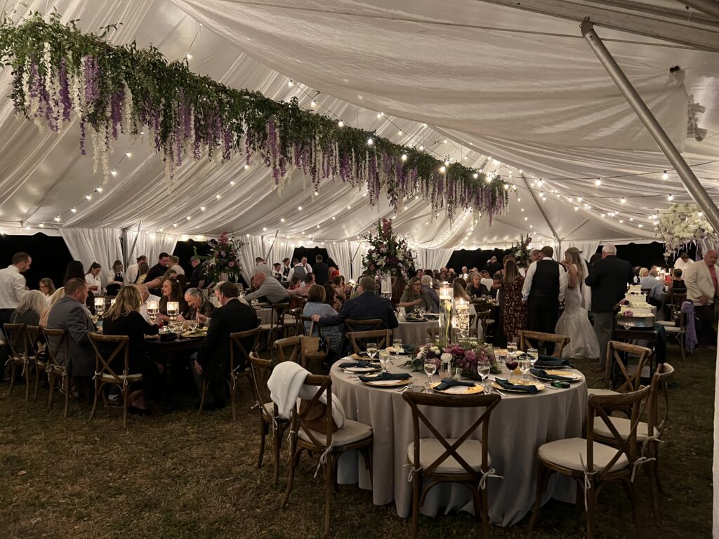 Stunning tent with draping, lighting and gorgeous hanging floral installation