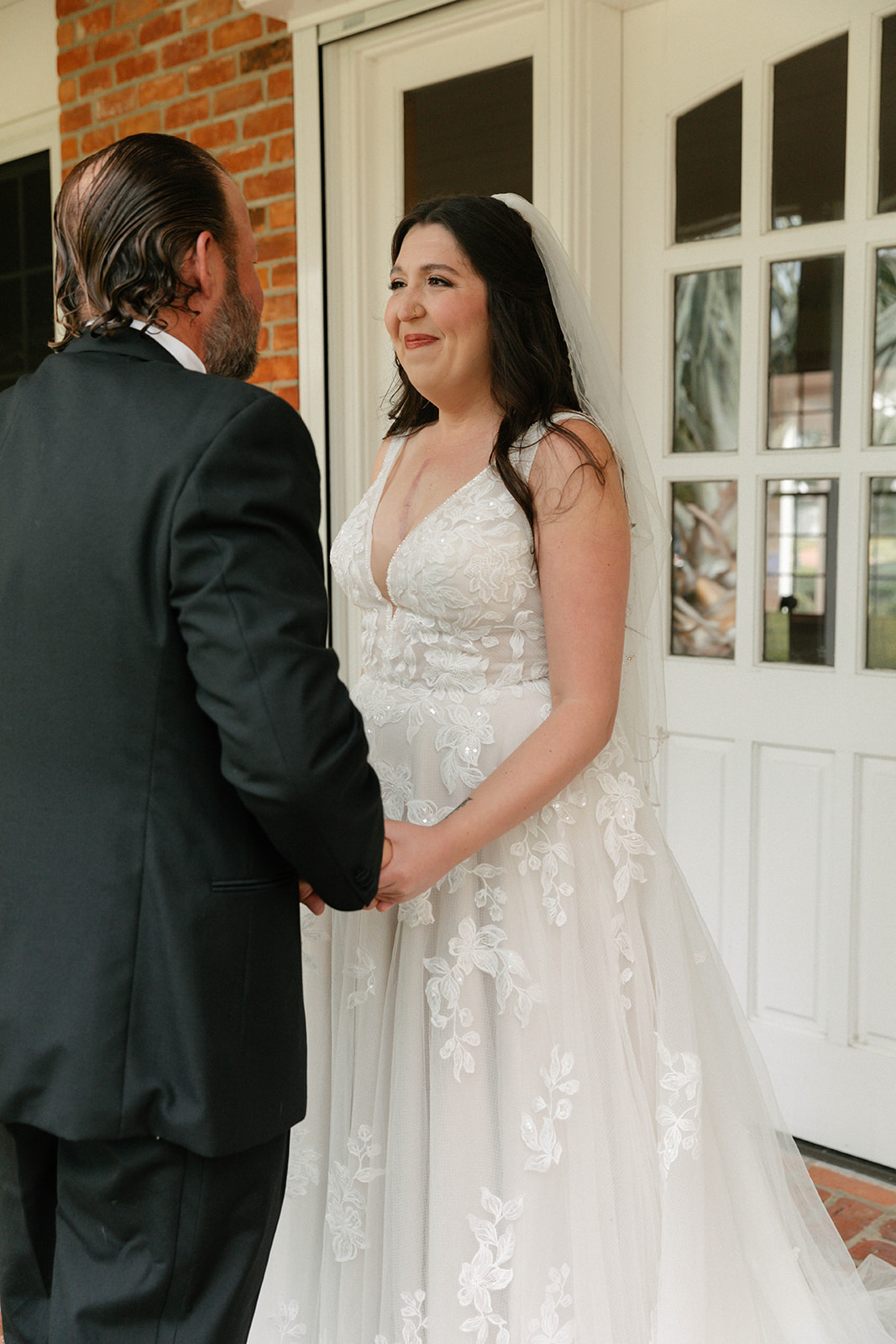 Bride and father of the bride having first look on front porch